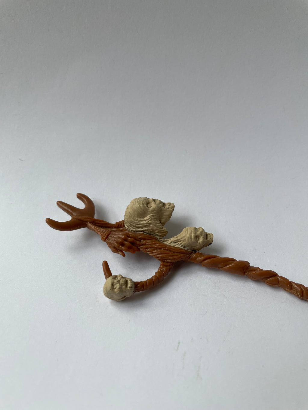 Decorative twig with three small animal figurines on a white background