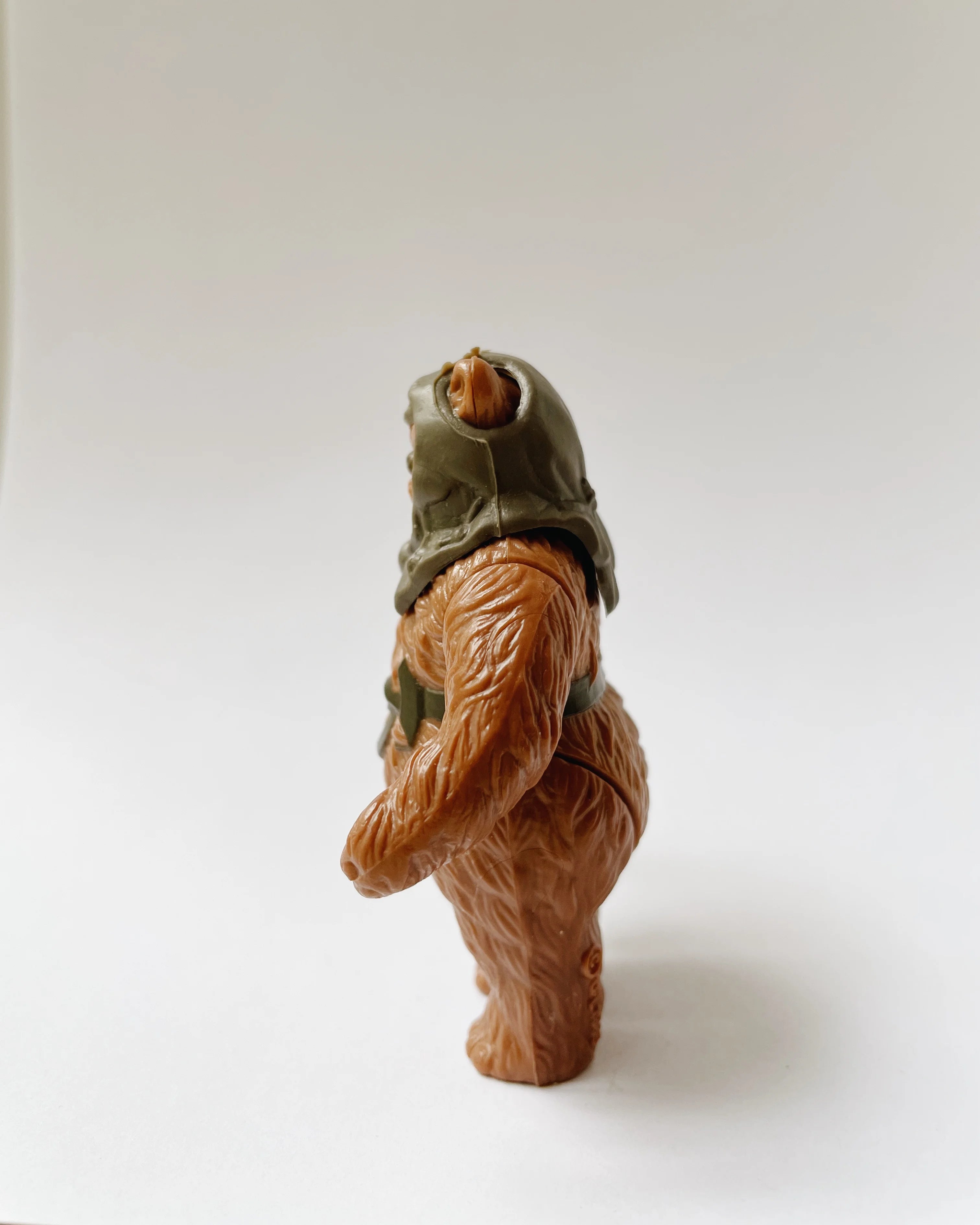 Toy figure of a character wearing a helmet on a white background