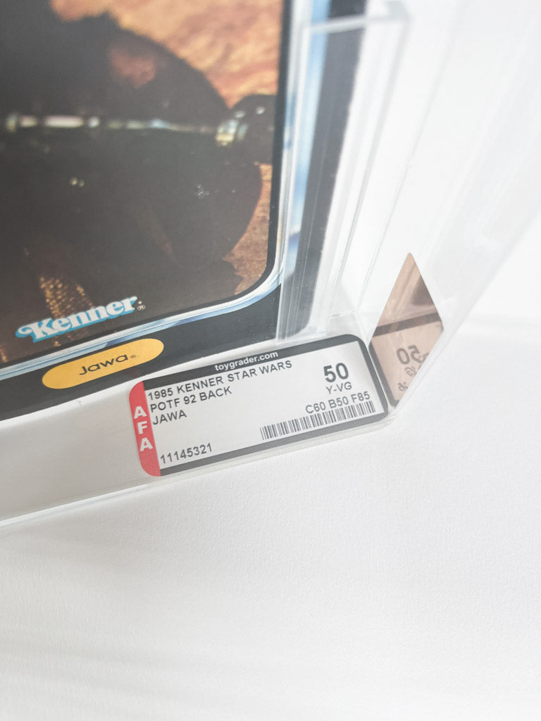 Close-up of a Kenner Star Wars toy with an AFA (American Fine Arts) label on a white surface.